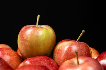 Group of fresh organic red whole apples on a black background