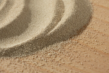 Dry yeast scattered on wooden surface, copy place for text.