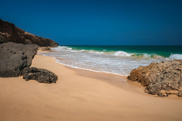 Beautiful tropical beach on Boa Vista Island, Cape Verde, featuring golden sand, clear turquoise water, and a sunny blue sky &ndash; ideal travel and vacation destination
