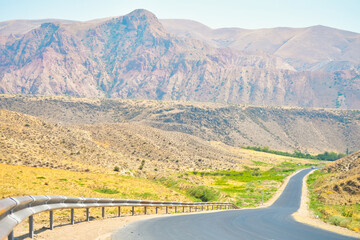 Asphalt road in mountains in Armenia countryside with no cars. Road trip caucasus in summer concept
