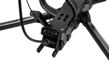 Close-up of a rear power connector and antenna port on a carbon fiber FPV racing drone, isolated on white back