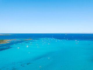 Summertime vacation. Sailing yacht at sea. Drone view on the yacht. Sea and waves from top view. View on the coast from drone. Background, wallpaper, postcards.