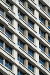 Modern Office Building Facade with Repetitive Window Pattern and Concrete Grid Architecture