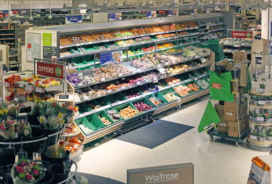 Shelves in large popular upmarket grocery store interior Waitrose in London, UK Waitrose is a food retail division chain of British supermarkets