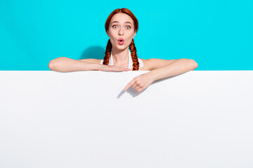 Fototapeta premium Photo of pretty young girl point finger proposition ad isolated on teal color background