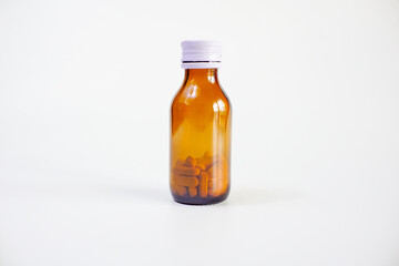 brown glass bottle for supplement product isolated on white background with clipping path