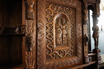 Fototapeta premium Detailed carved wooden cabinet with intricate artistry and historical elegance