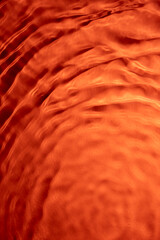 Abstract fluid lines – orange reflective surface
