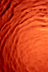 Abstract water ripple texture in soft orange tones
