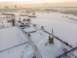 Aerial view of a windmill in a snow white winter landscape on the outskirts of Brussels, Belgium