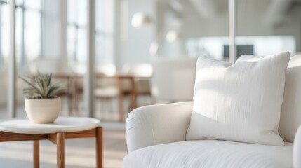 An inviting image of a modern white sofa in a bright office setting, highlighting comfort and contemporary design in a professional environment.