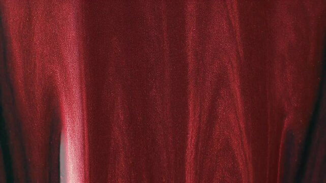 Vertical red shimmer abstract background for makeup and nail polish aesthetics in luxurious liquid stain style 