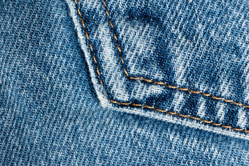 Macro fabric texture of cotton blue jeans. Pocket and thread stitching