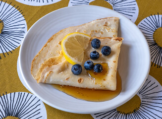 Pancake day, home cooked pancakes with blueberries and maple syrup