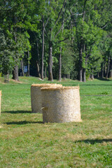 Haystack harvested in cereal field. Rolls of hay bales in a field. Hay is prepared in a roll for storage in winter. Agricultural scene on the polish countryside