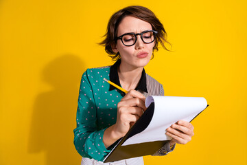 Photo of charming adorable woman wear trendy clothes write contract isolated on yellow color...