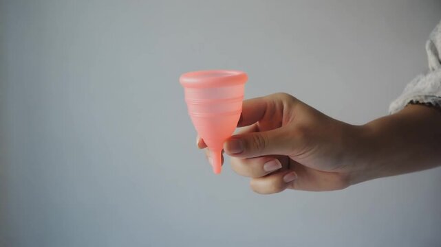 Hand with a menstrual cup.