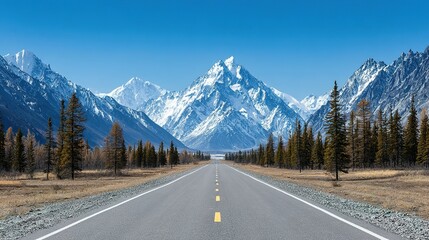 Scenic mountain road under a clear blue sky.