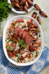 A delicious Brazilian dish of rice with sausage, bacon and pine nuts