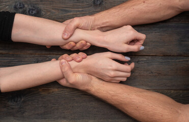 masculine hands violently grip woman's slender wrists. Dominating masculine fingers encircle...