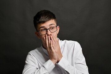 Body language tells story of personal stress or shocking discovery. hands are raised to mouth....