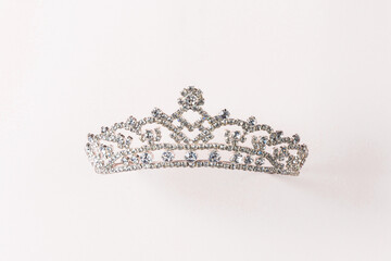 Sparkling Tiara Shines on Soft Pink Backdrop © Ilya Postnikov