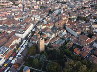 Fototapeta premium Aerial drone view of Rovigo city center, Veneto, showcasing the medieval Donà Tower, ancient castle ruins, and a mix of historic and modern buildings.