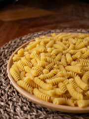 Raw Fusilli Spiral spaghetti pasta pattern background.