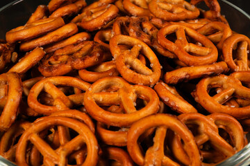 Mini pretzels sprinkled with salt filling a glass bowl