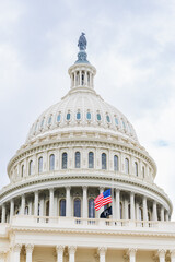 Fototapeta premium Close-up of the U.S. Capitol dome with American and POW flags flying at half-staff.
