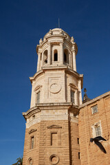 Bell tower of the Cathedral of Cadiz, Spain, with baroque details under clear blue sky