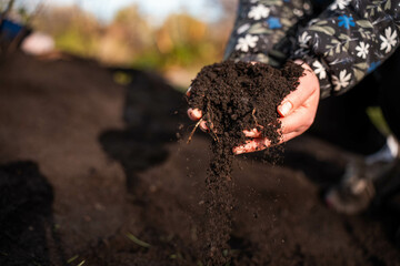 turning a compost pile in a community garden. compost full of microorganisms. sustainable...