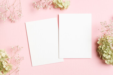 Two white invitation cards with copy space for design presentation, blank mockup with hydrangea and...