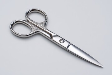 Fototapeta premium Close-up studio shot of elegant stainless steel scissors with decorative handles, showcasing their precise craftsmanship, sharp blades, and ergonomic design, on a soft grey background.