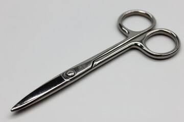 Fototapeta premium Close-up shot of stainless steel surgical scissors against a clean, white background, highlighting the precision and sharpness of the medical instrument for various applications.