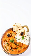 Chicken tikka masala in copper pan with basmati rice and naan bread isolated on white background, Indian cuisine, creamy curry, copy space