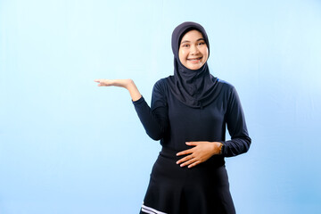 A woman wearing a black dress and a black head scarf