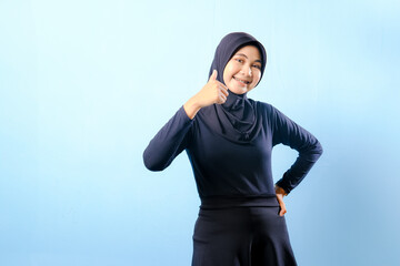 A woman wearing a black dress and a black head scarf
