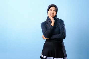 A woman in a black skirt and a hat is looking up at the sky