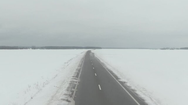 Aerial Drone Shot of Old Soviet Truck Driving Through Snowy Rural Landscape in Harsh Russian Winter