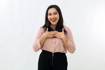 Young Asian woman surprised and grateful for good news, holding hands on chest smiling, saying...