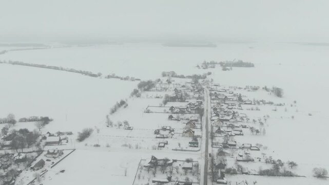 Aerial Drone Shot of Old Soviet Truck Driving Through Snowy Rural Landscape in Harsh Russian Winter