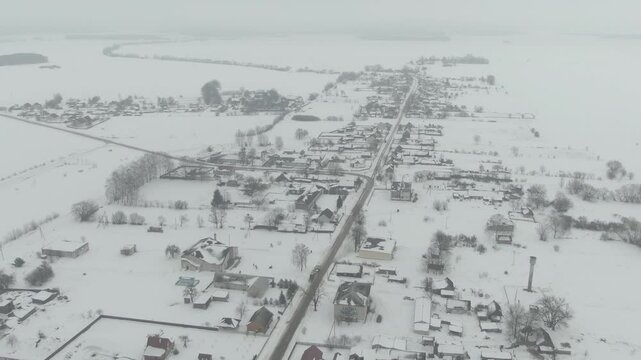 Aerial Drone Shot of Old Truck Driving Through Snowy Rural Landscape in Harsh Russian Winter