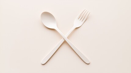 Minimal white spoon and fork crossed