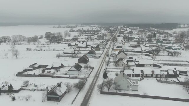 Aerial Drone Shot of Old Truck Driving Through Snowy Rural Landscape in Harsh Russian Winter