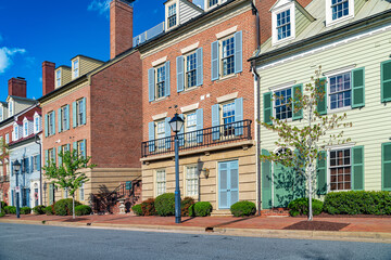 residential complex with rows of three-story modern brick houses along the road.