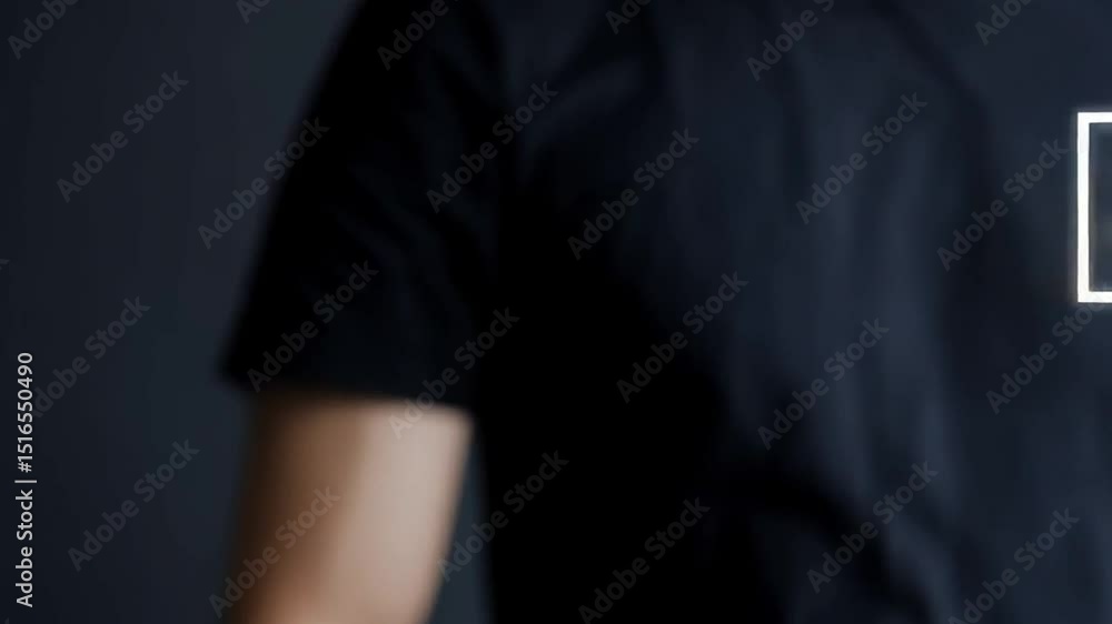 Poster person selecting a happy face on a digital survey interface with dark background and black shirt
