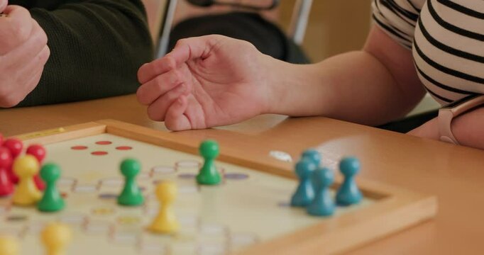 retirees playing boardgame Mensch &auml;rgere Dich nicht at retirement home