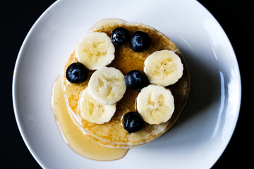 Fresh Pancakes With Sliced Banana Blueberries And Honey
