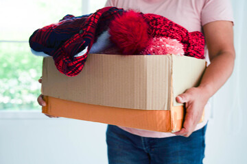 Clothes donations in cardboard box for volunteer.